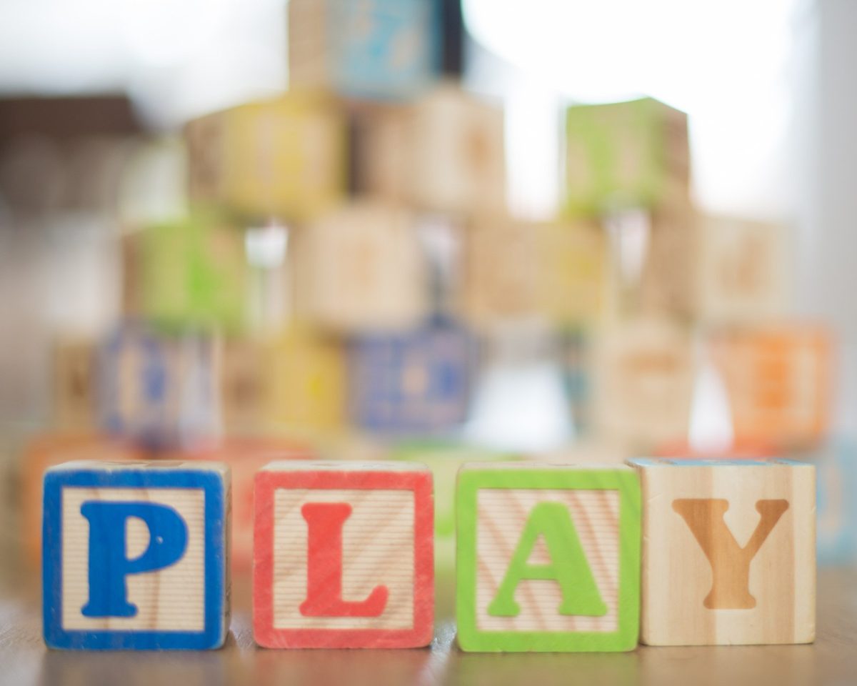 Wooden alphabet blocks spelling the word play